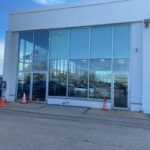 Side view of Ken Ganley Volkswagen showroom windows during 3M Affinity 15 installation by Sunray Window Films.