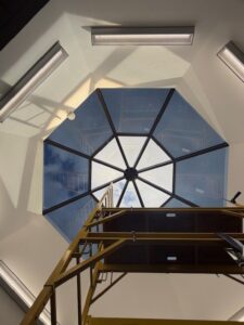 Sunray installer applying additional pieces of 3M Affinity 15 film to skylight panels.