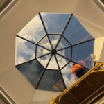 Installer beginning application of 3M Affinity 15 window film to skylight panels at Cleveland Clinic.